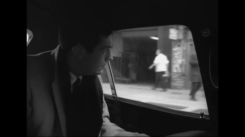 CIRCA 1969 - Bill Bradley is driven through New York City, and a narrator talks about the drive of his social conscience.