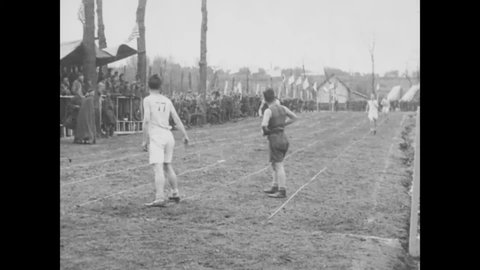 CIRCA 1910s - Soldiers of the 35th and 77th Infantry Divisions participate in a relay race n Olympic sporting event, Le Mans Embarkation Center.