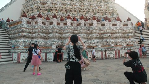 Bangkok, Thailand - Jan 25, 2020 : Tourists in asian Temple Wat Arun. Wat Arun is famous Buddhist temple in Bangkok Thailand.