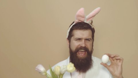 Funnyman wears bunny costume accessories and dance. Funny Easter bunny or rabbit. Happy Easter