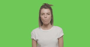 Young girl wear white t-shirt chewing bubble gum over green screen background, Chroma Key 4k raw video footage slow motion 60 fps