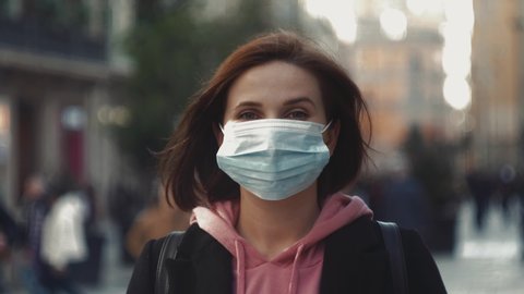 Pandemic, portrait of a young tourist woman wearing protective mask on street crowd people. covid concept health and safety, N1H1 coronavirus quarantine, second wave covid virus protection