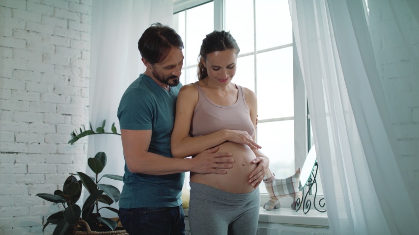 Father's hand on a pregnant stomach - Free Stock Video Footage