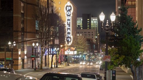 Broadway Street and view of the iconic Portland sign in downtown Portland, Oregon at night timelapse. Portland, Ore / USA - January 2020.