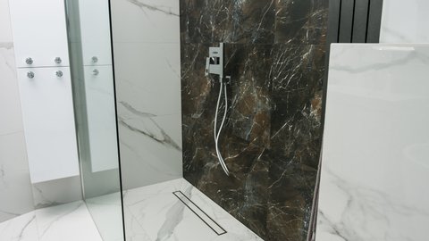 Luxurious house bathroom shower, white marble and black marble walls bathe