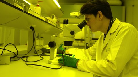 
Asian scientist working in the yellow lab,Researchers are research to find the results of the experiment,doctors are testing bloods to prevent and destroy new strains of the coronavirus	