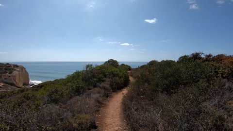 POV Walking along a trail between Caneiros Beach and Ponta do Altar, during the winter season, Carvoeiro - Algarve, south of Portugal