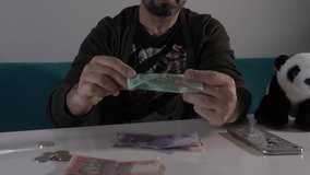 Man counting Ukrainian coins on desk Macro Detail 4K video footage Finance money economy.