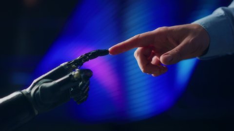 Humanoid Robot Arm Touches Human Hand, Connecting Fingers. Humanity and Artificial Intelligence Unifying Gesture.Technology Merges with Creative Human Mind. Inspired by Michelangelo's Creation of Adam