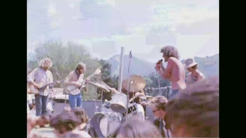 CIRCA 1960s - Hippies throw a concert in a park, LAPD break up and arrest young man for drug offenses, Los Angeles, 1968