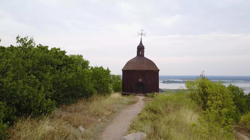 Aerial footage of a old small church on the banks of the Dnieper River