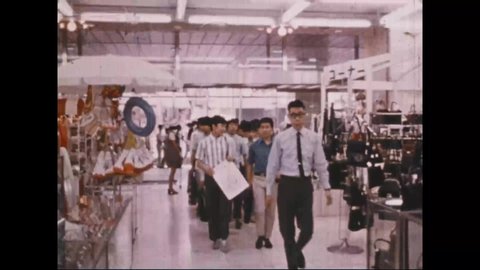 CIRCA 1971 - Shoppers are seen in a Tokyo department store while the narrator gives stats about Japan's economy.
