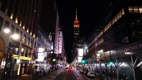 NEW YORK CITY, USA - January 15, 2020: 4k slow motion. Night drone shot of Empire State Building, iconic skyscrapers in New York City Manhattan. NYC is a modern urban city, destination in America.