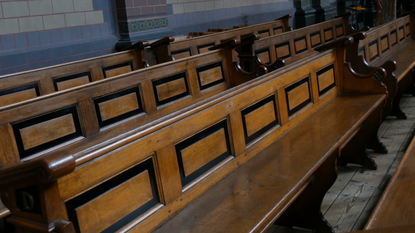 Old wooden benches in catholic church. Wooden Pews in a Christian Church Aisle. The Christian church aisle. Architecture Christian Orthodox Church Interior. Altar and religion | Shutterstock HD Video #1045644550