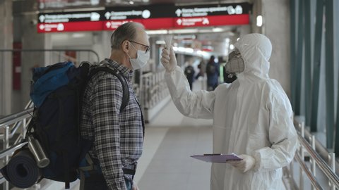 Screening of passengers, travellers for Chinese coronavirus symptoms. Temperature checkpoints in International airports. People may be infected by deadly coronavirus examined, virus spread prevention