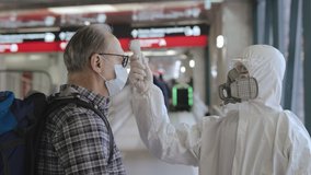 Screening of passengers, travellers for Chinese Covid-19 coronavirus symptoms. Temperature checkpoints in International airports. People may be infected by deadly coronavirus examined, close up shot - Powered by Shutterstock - Get 15% off with code: PIKWIZARD15