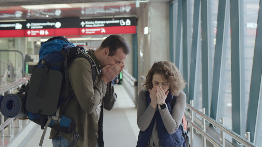 Unhealthy tourists suffering from sneezing and coughing among people in public place. People cough at arrival area of international airport. Virus Covid-19 spread, epidemic alert Royalty-Free Stock Footage #1045645648