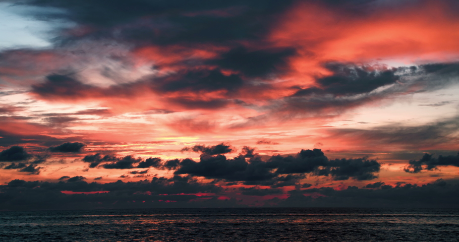 Bright unusual red-orange sunset over the tropical coast. Southeast Asia, Thailand/Thai, Indian ocean, Andaman sea. Wonder of nature