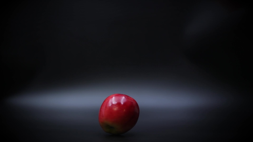 Slow Motion View of a Ripe Red Apple Spinning on a Black Surface. - Powered by Shutterstock - Get 15% off with code: PIKWIZARD15