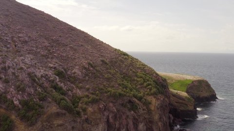 Aerial parallax of epic cliffs and volcanic formations in White Island, New Zealand