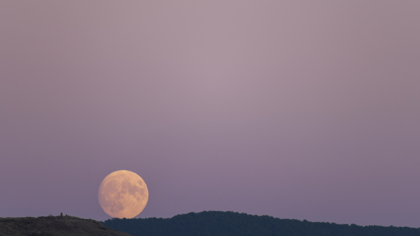 Shiny Full Moon Rising On Purple Sky
