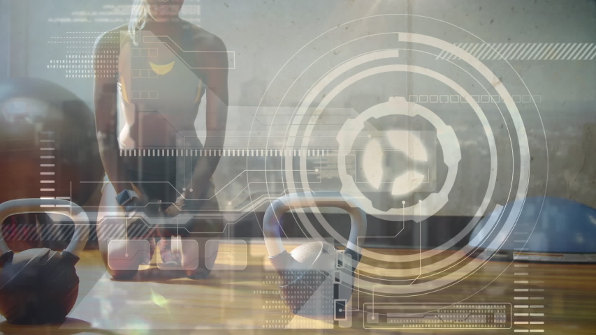 Animation of data processing, scope scanning and analytics with a woman working out in a gym doing push ups on kettlebells in the background - Powered by Shutterstock - Get 15% off with code: PIKWIZARD15