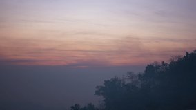 Timelapse sunrise  above the mountain. Dust, fog and haze scene. 4K Video.