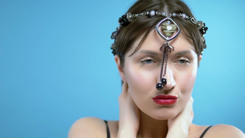 the girl wears a head beads of black agate with pendant in the shape of a heart.