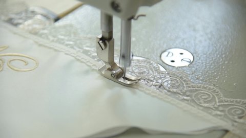Stitching machine stitches white lace