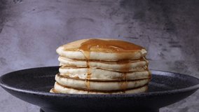 Pancakes with Maple Syrup Being Poured Over Them