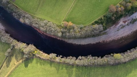 River meander 4K aerial drone footage in lush countryside valley UK