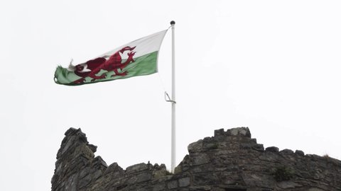 Welsh flag fluttering in wind, Harlech Castle, Wales