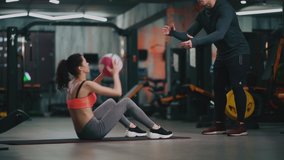 personal trainer with woman exercising with fitness ball in gym - Powered by Shutterstock - Get 15% off with code: PIKWIZARD15