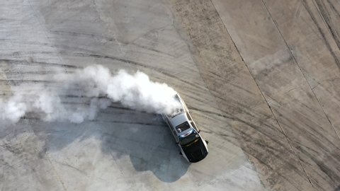 Drifting car, Aerial view professional driver drifting car on asphalt race track with black tire skid mark texture and background, Race drift car with smoke from burning tires on speed track, 4k