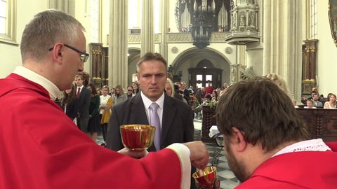 BRNO, CZECH REPUBLIC, SEPTEMBER 24 , 2019: Catholic christian priest hands out sacramental bread altar communion