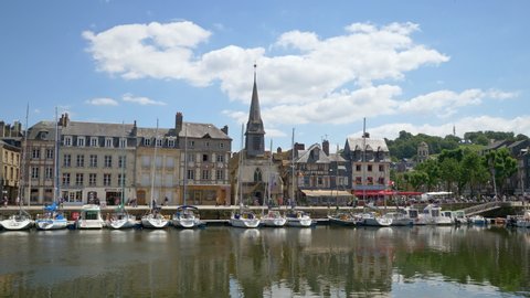 HONFLEUR, FRANCE - JUNE 2018: Honfleur harbour old port with beautiful houses and lots of yachts. Honfleur is located in the northern region of Calvados, Normandy, France.