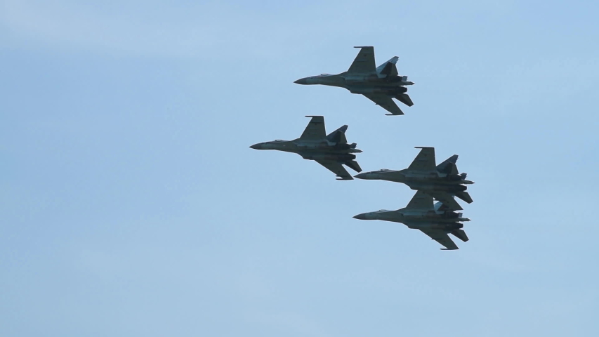 Supersonic fighter jets team in formation flying in the sky. Military aviation | Shutterstock HD Video #1045734604