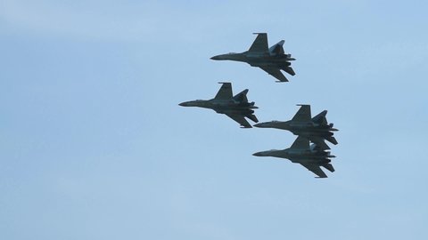 Supersonic fighter jets team in formation flying in the sky. Military aviation