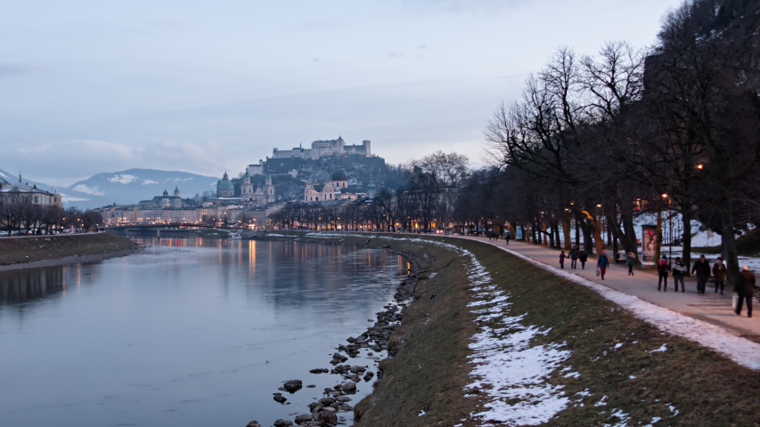 Day to night hyper lapse of Salzburg old town, Hohensalzburg Fortress, Salzburg Christuskirche and Salzach riverside, Austria.