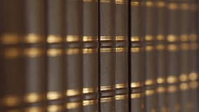 Female hand chooses a book in the library with a luxurious leather binding. 4k - Powered by Shutterstock - Get 15% off with code: PIKWIZARD15