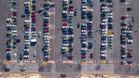 Aerial timelapse of a busy, crowded supermarket parking lot in daytime USA