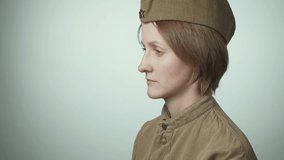 Video of woman wearing soviet army uniform on white