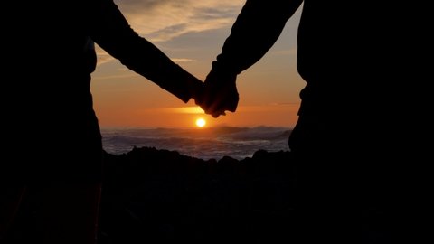 Dramatic break up Couple separating their hands at sunset, love story ending, family break-up at valentines day,closeup