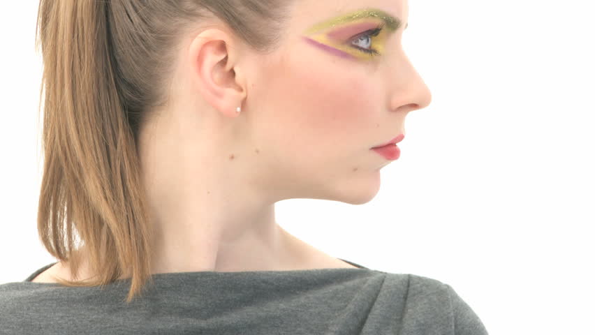 Young woman with garish make-up gives the 
