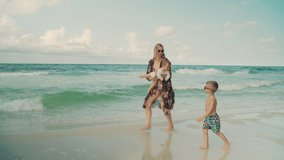 Young beautiful mother walking with her little kids along the beach. Florida Panama City Beach USA - Powered by Shutterstock - Get 15% off with code: PIKWIZARD15
