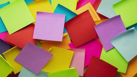 Colorful blank sticky notes being dropped onto canvas board - stop motion animation, business reminder concept