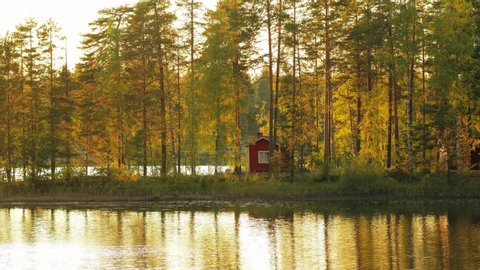 Traditional Finnish sauna on the shore of lake during ruska autumn time in Finland