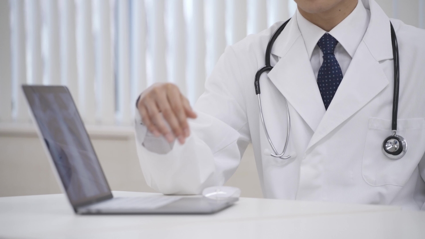 Young doctor examines a patient x-ray