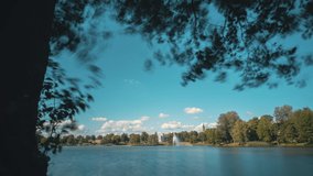 Beautiful 4k time lapse video of resort city Druskininkai in Lithuania. Taken across Druskonis lake in the foreground and city church and museum in the background. During tourist summer season.