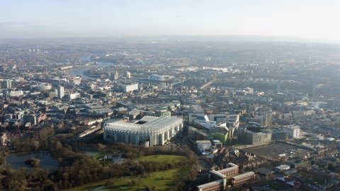Newcastle upon Tyne aerial view, known as Newcastle, is a city in Tyne and Wear, North East England. Flying above the city ft. St James Park football stadium, park, river and central buildings in UK